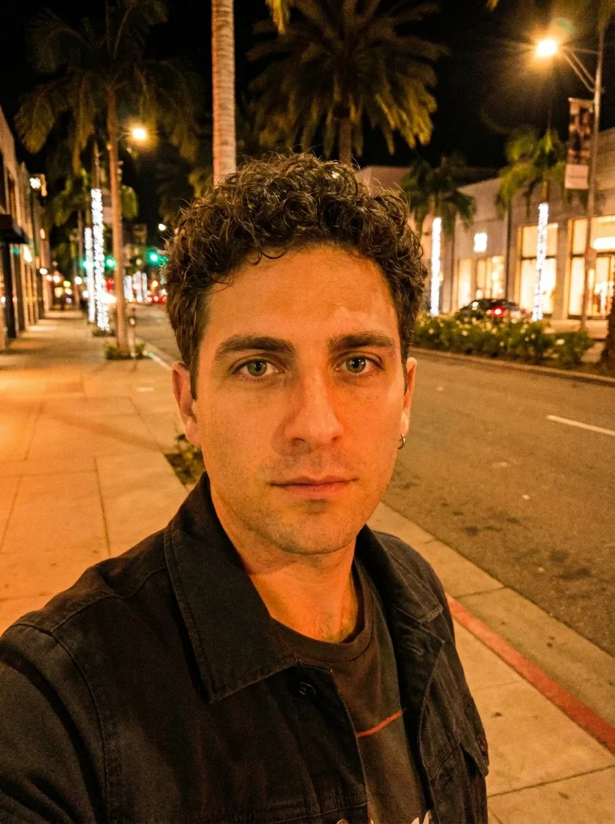 Original selfie input — man in a dark jacket on a night street